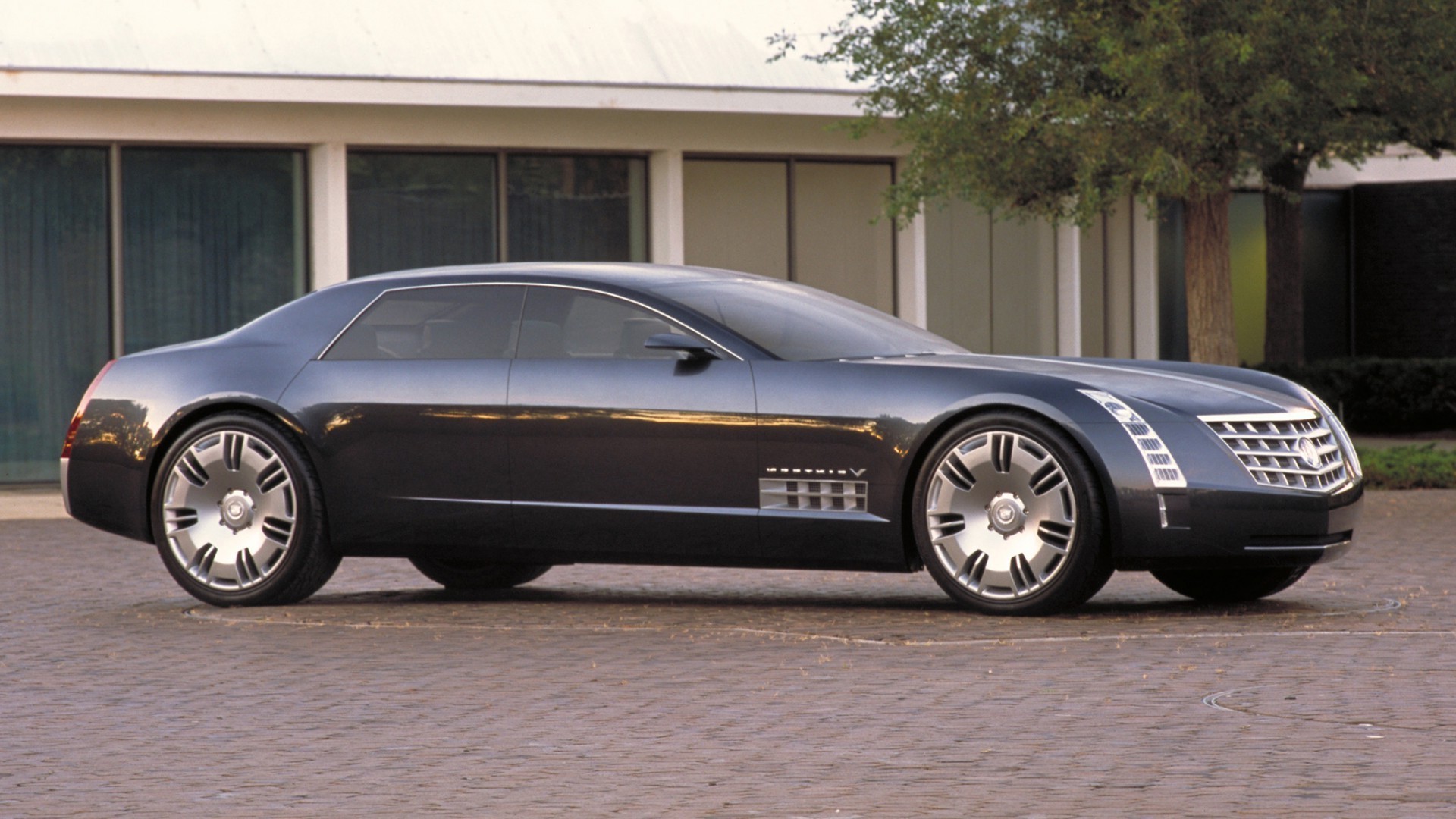 car vehicle noon wheel blacktop pavement asphalt transportation system automotive coupe action