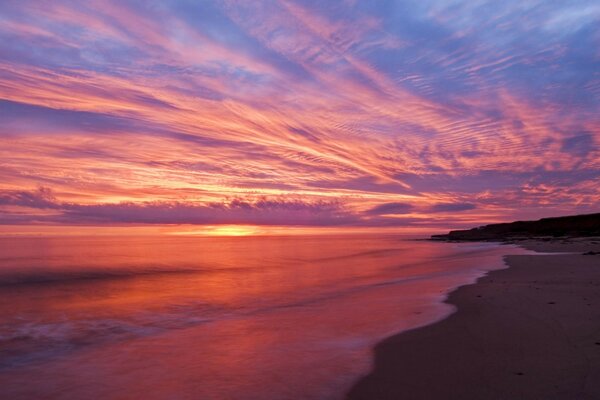 Charming crimson sunset over the water