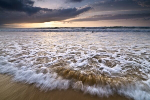 Sea surf on a sandy beach