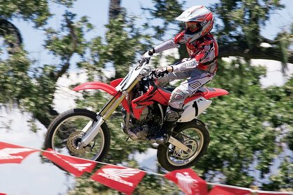 The rider takes off on a bike above the flags